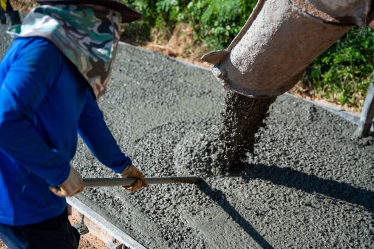 Concrete pouring during commercial concreting floors at road
